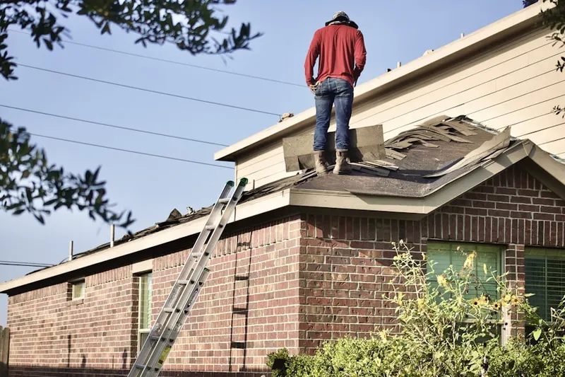 Professional roofer working on a residential roof in Golden Hills